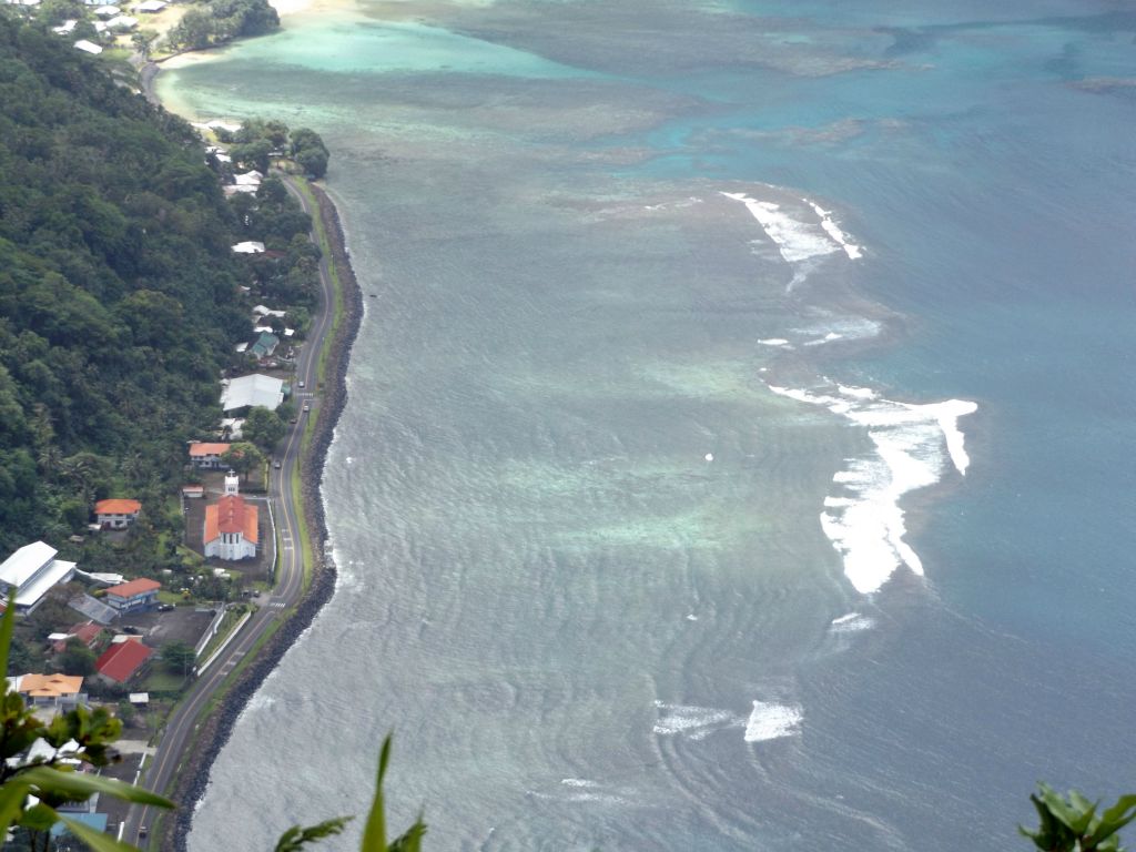 Looking down at waves breaking over the coral reef of Pago Pago Harbor: