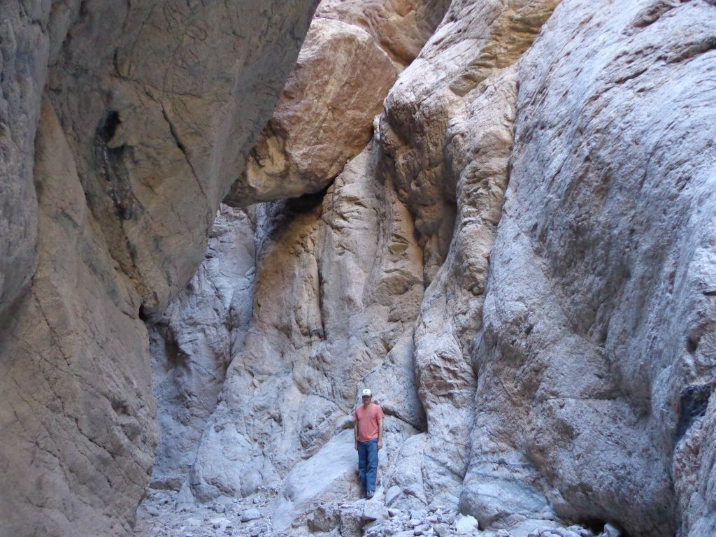 In this picture of Steve, you can see the first of two boulders which are wedged high up in between the canyon walls: