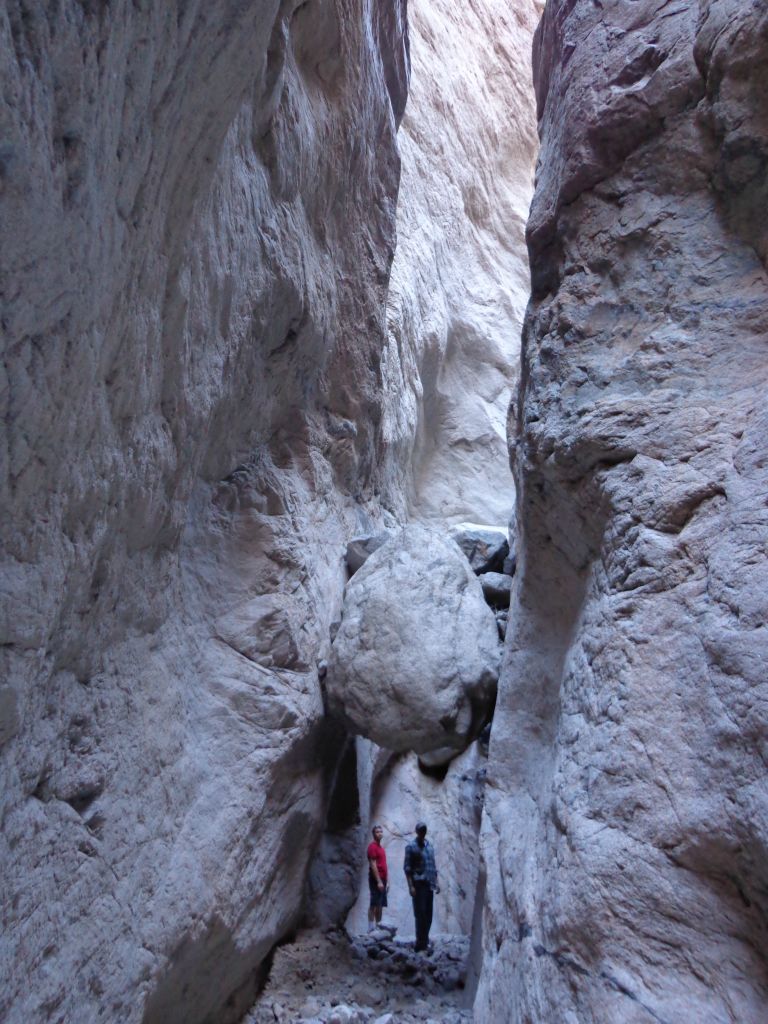 Jered and Charlie standing behind the second wedged boulder which is near the major dry fall: