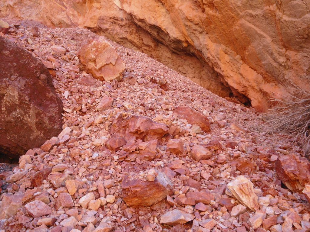 Pieces of rock had fallen off of the bright orange wall creating a slide area: