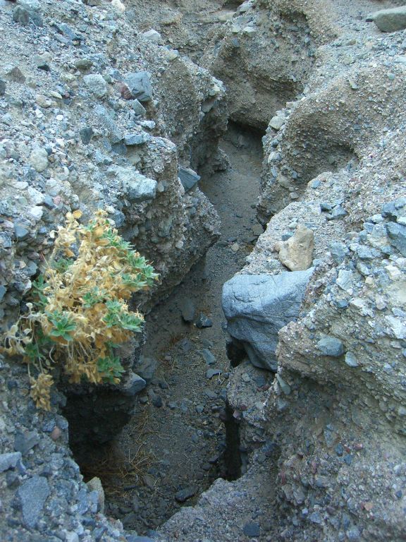 Climbing another small dry fall and looking back down the very narrow trench: