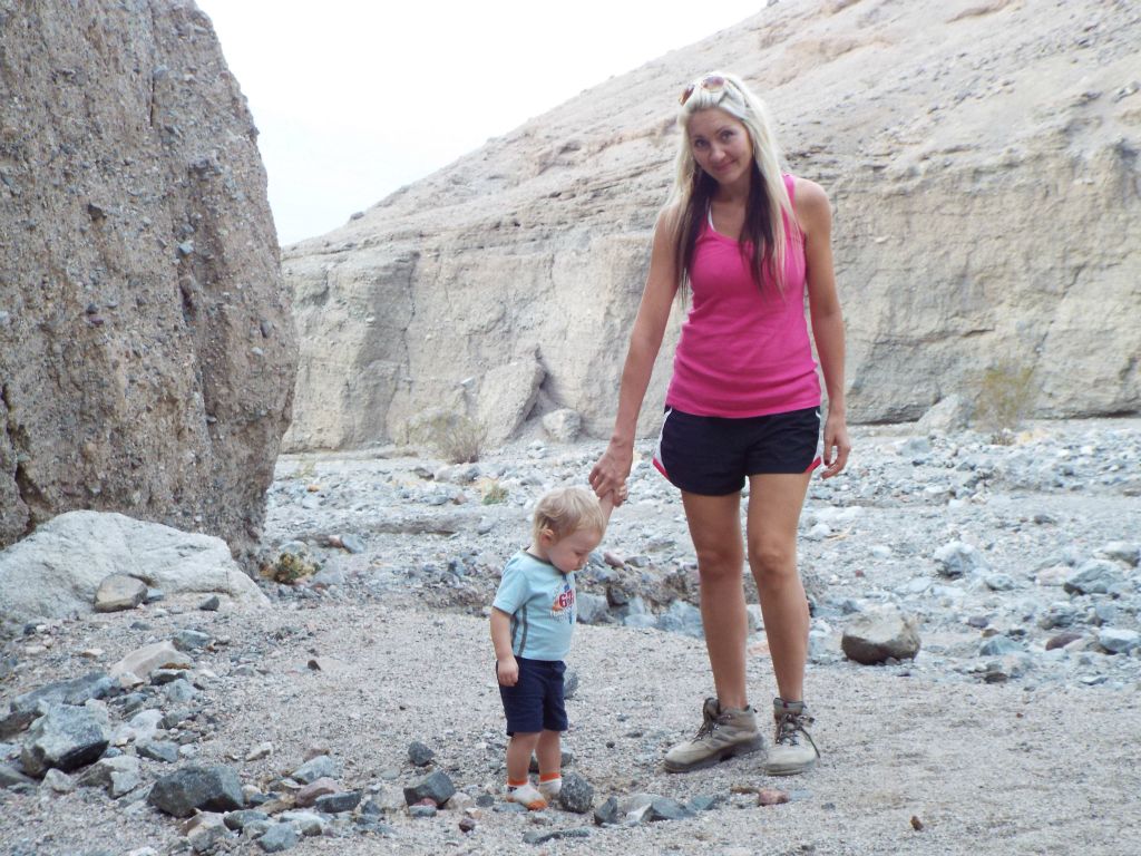 Two pictures of Stefan playing in the sand and gravel outside of the entrance to Slot #2: