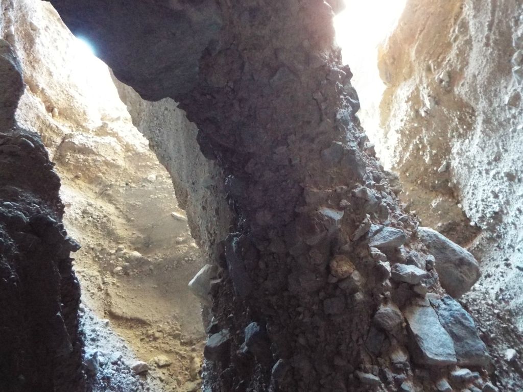 The angled column of the natural bridge extending down towards the wash: