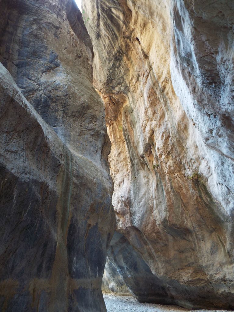 A stunning contrast of blue, grey, and tan rock walls: