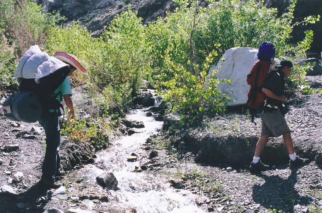 The first Panamint City backpacking trip of my life was taken with Rob, Joe Silva, and Josh.  In this photo, Rob and Silva are crossing a stream in early Surprise Canyon: