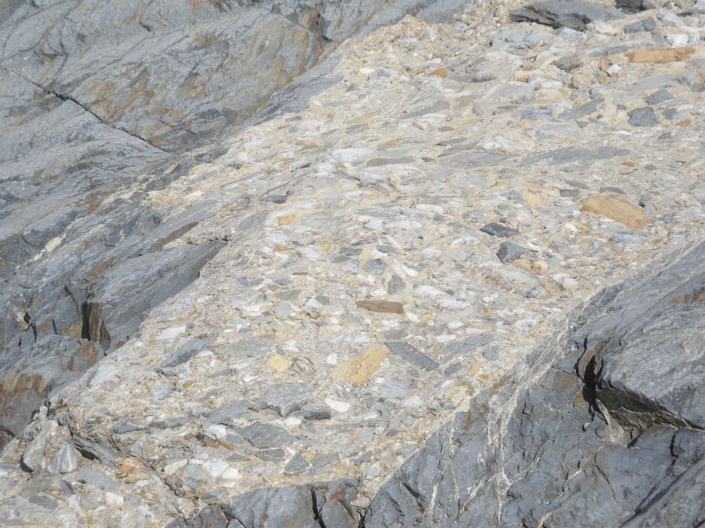 Breccia rock and conglomerate rock were everywhere once again.  From what I understand, breccia rock has angular distinct edges to the rock fragments while conglomerate rock has rounded edges: