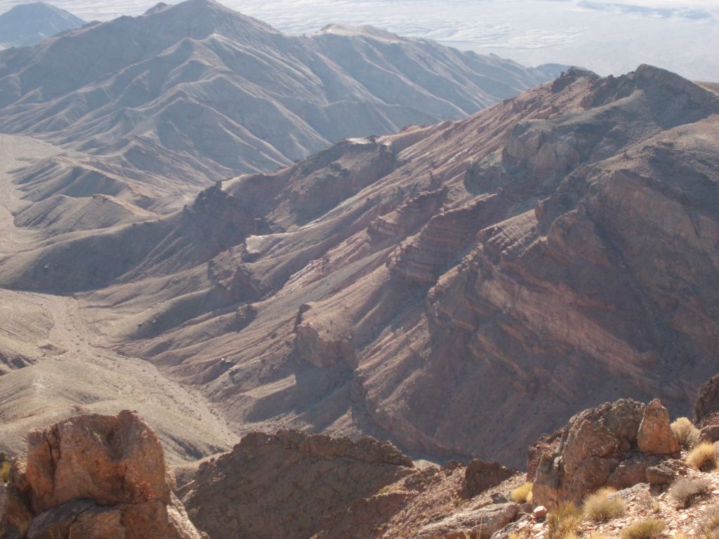 Looking down at the pretty rock texture on the mountainside and wash far below us: