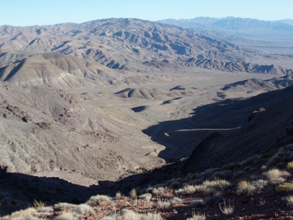 Finally standing on the saddle where we met up with the trail to the spring.  In the distance here, you can see where our wash meets up with the wash we hiked in on earlier.  The saddle is located at about 4,675 feet in elevation: