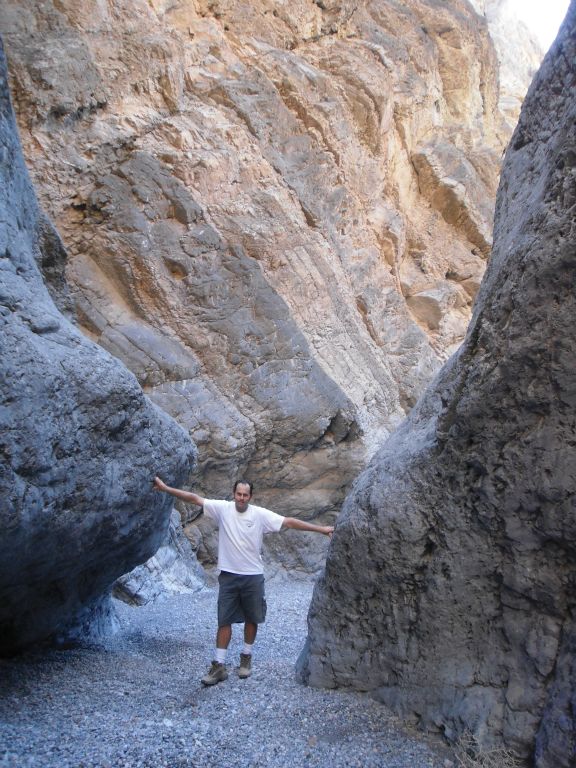 Steve passing by one of many spots where he could touch both walls of the canyon: