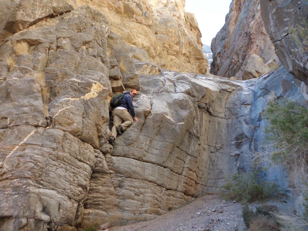 Using a lot of arm strength, he makes it up the first portion and looks back: