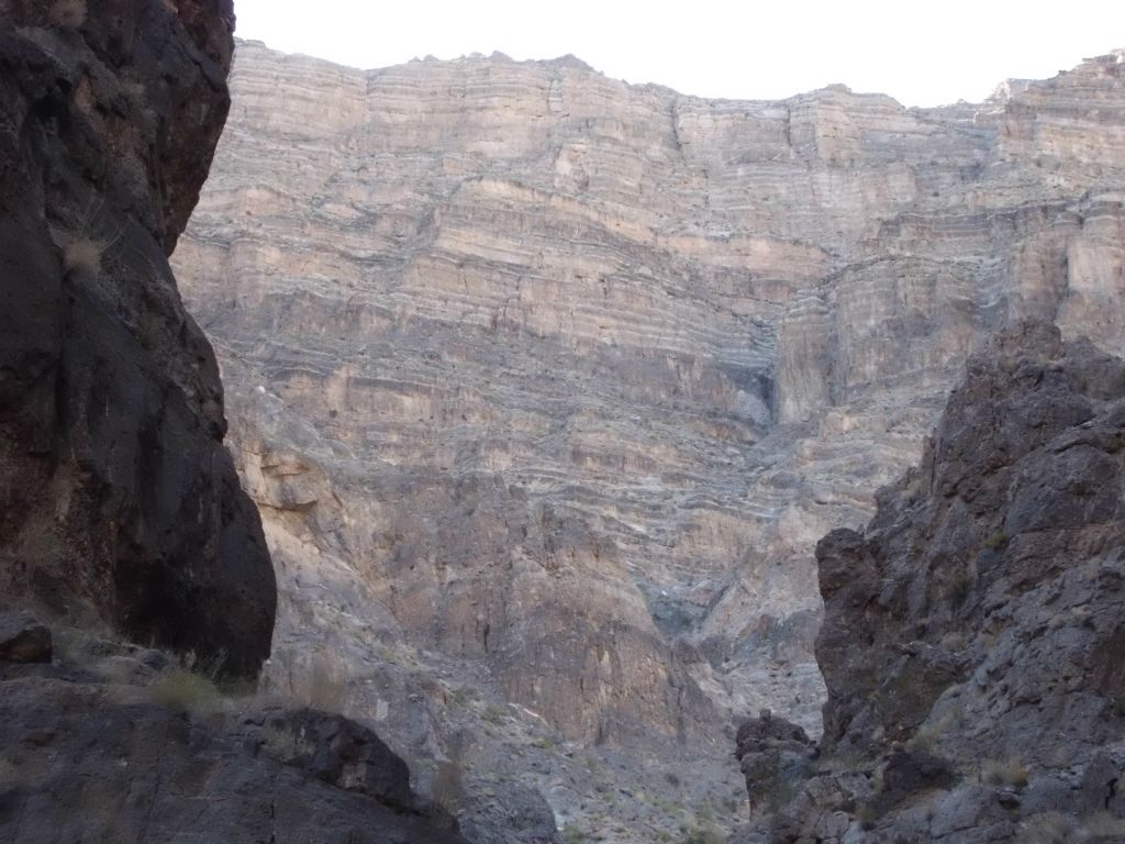 Scenery reminiscent of the lower canyon with towering walls high above: