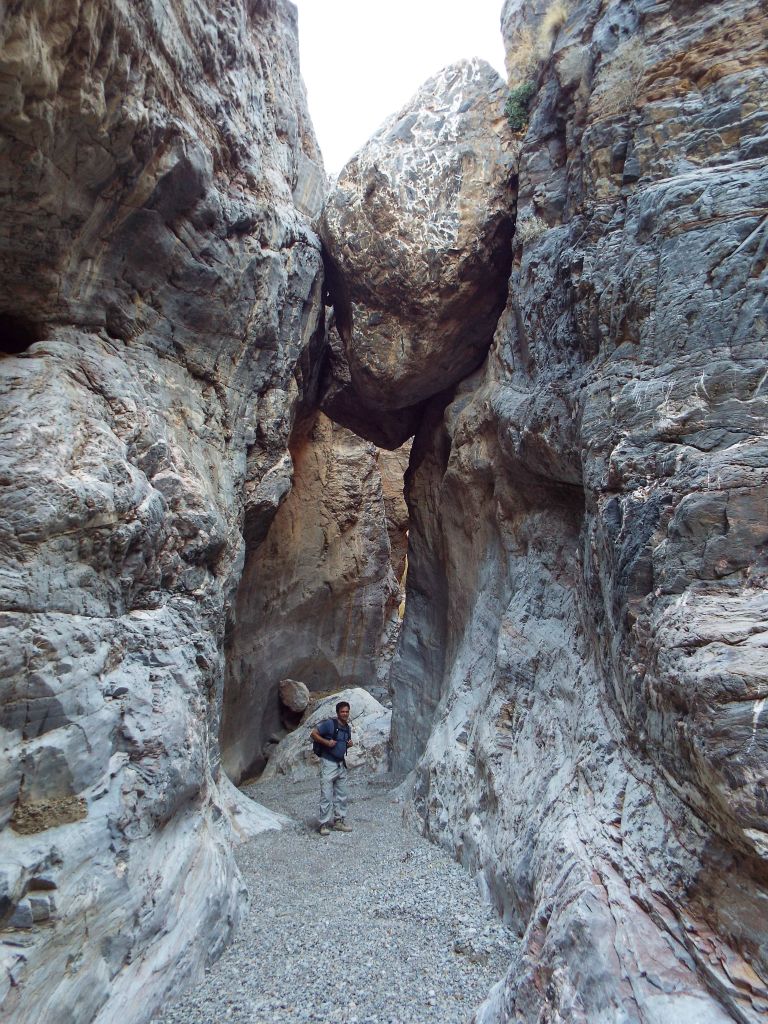 A picture of Mel underneath the massive wedged boulder: