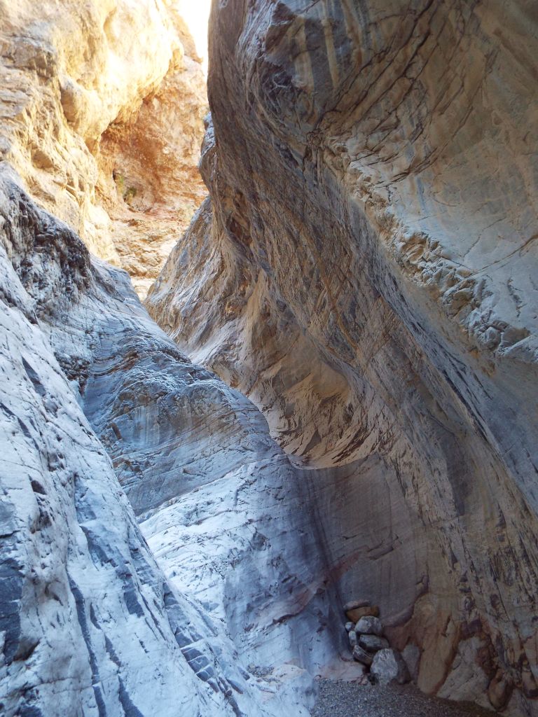 This picture shows the 2nd major obstacle, a polished dry fall with no hand holds.  Previous hikers had stacked rocks here at the base to give themselves a boost: