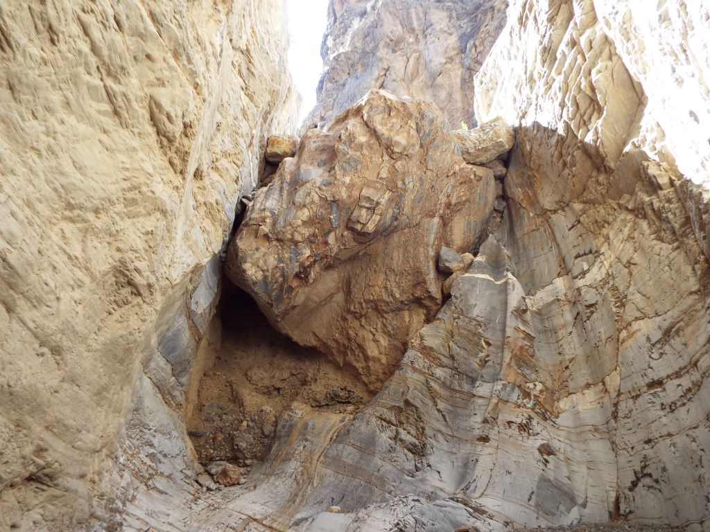 This huge boulder jam is the 4th obstacle and our stopping point for this hike.  Above the boulder, we spotted a rappel sling somebody had left behind.  On a future trip, I hope to come back and find a safe way to access the middle canyon: