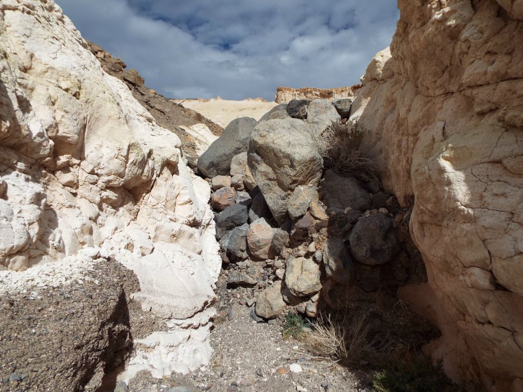 Instead, all hikers must take the left fork and climb over this smaller boulder blockade: