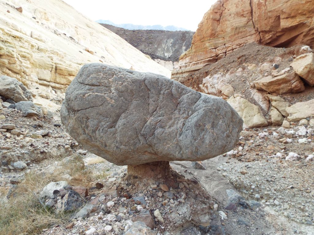 Check out the minimal support that this giant boulder has while sitting on a conglomerate rock display pedestal: