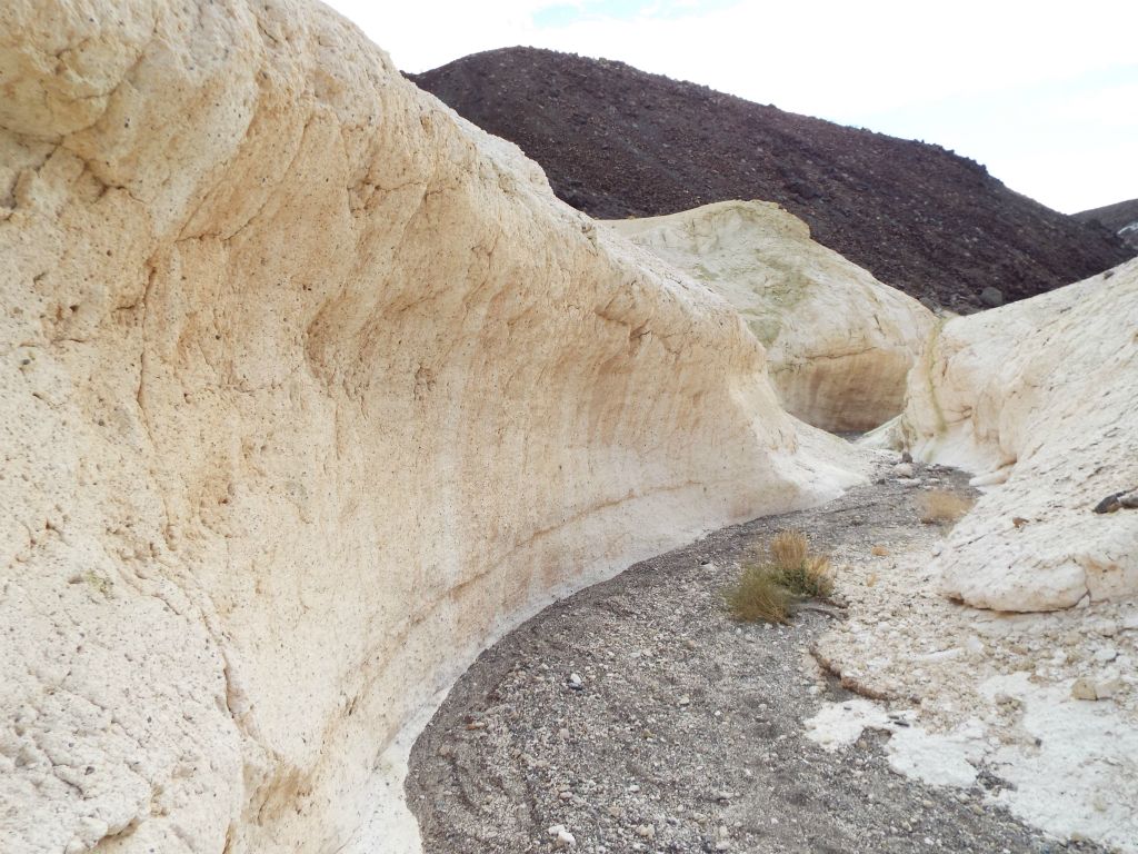 Wave-like curves on the canyon wall with dark rock in the background: