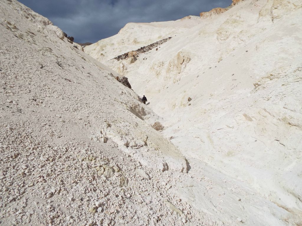 The "chalky" hillside extends toward the wash with Tobin hiking ahead in the distance: