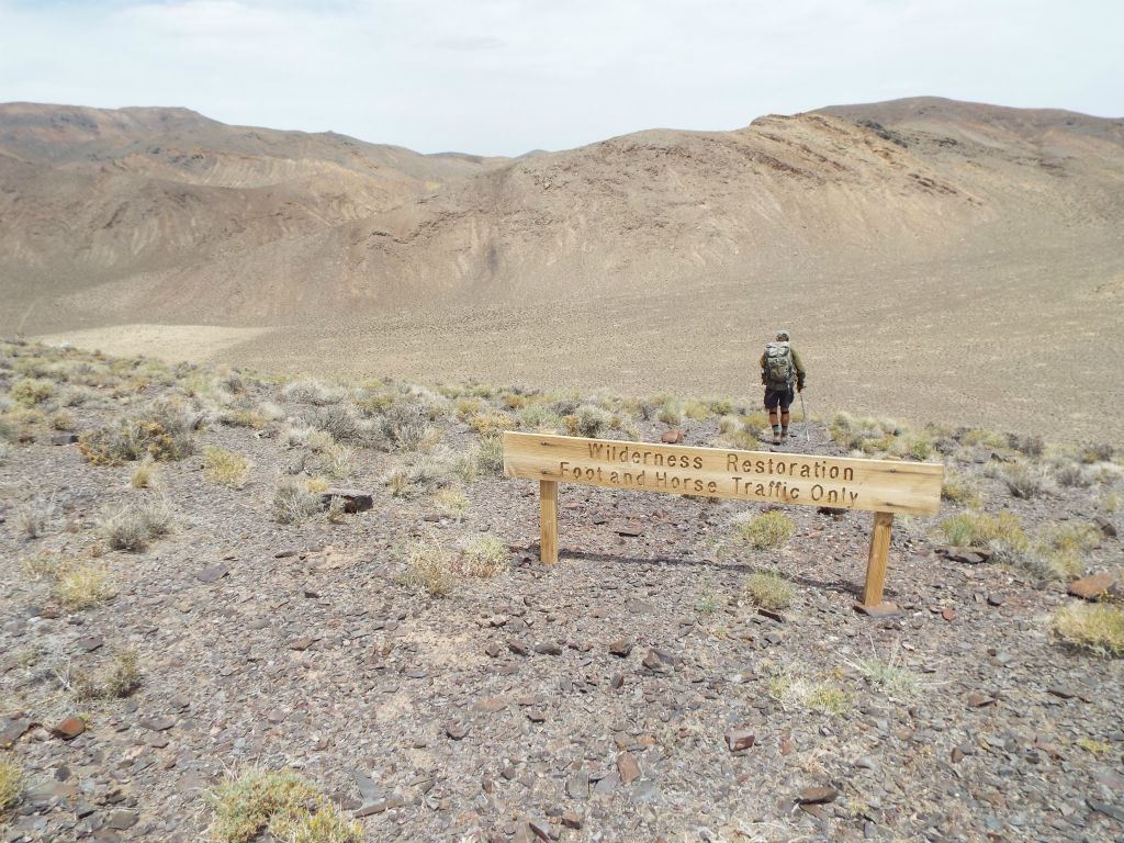 This Wilderness Restoration sign has been installed to ensure that visitors know where they must park and begin walking on the closed portion of the old road: