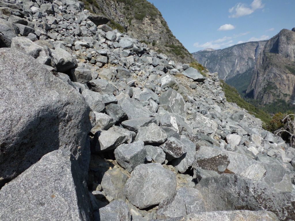 Instead, we stayed on the middle switchback and headed out towards the rock wall, which we were now nearly level with.  You can see the rock wall in the right center of this picture: