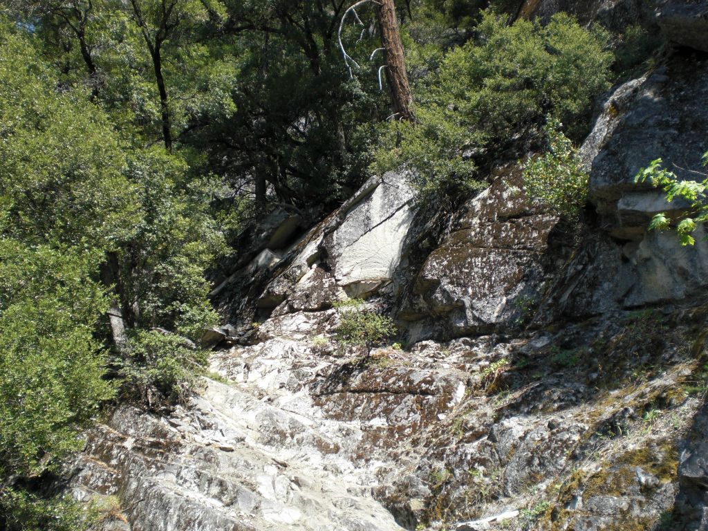 Looking at the top portion of the major obstacle.  The obstacle can either be climbed directly up or it can be crossed along the top ledge as seen at the middle right.  Both options present problems: