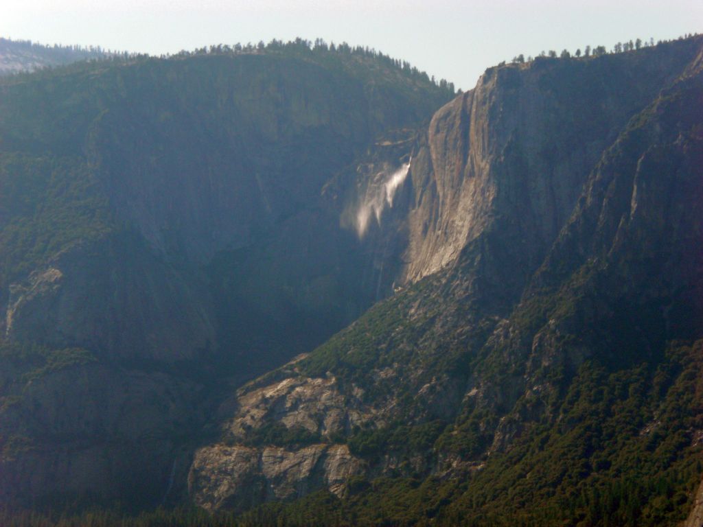 Two pictures zooming in on Yosemite Falls which shows the upper fall being blown around by the wind: